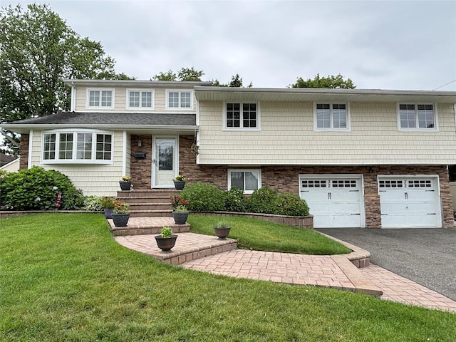 32 Sherman Dr, Syosset, NY 11791 - tri-level home featuring driveway, a front lawn, a garage, stone siding, and entry steps