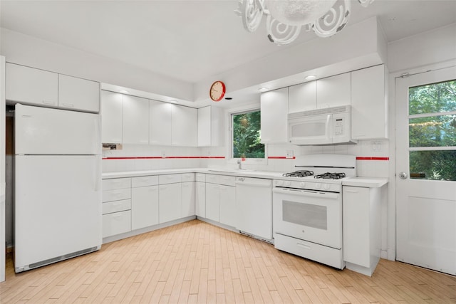 153 Waverly Rd, Scarsdale, NY 10583 - kitchen with white appliances, light countertops, and white cabinets