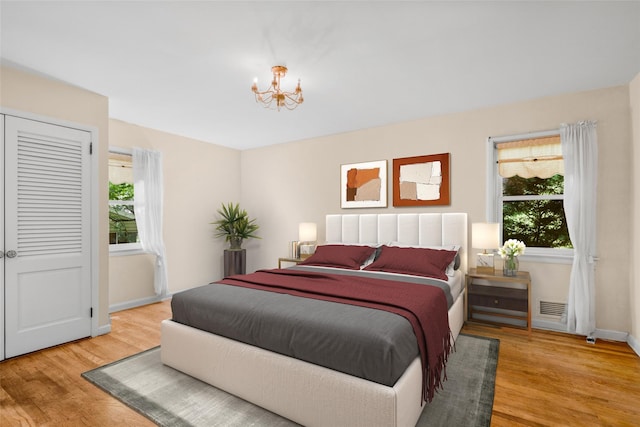 153 Waverly Rd, Scarsdale, NY 10583 - bedroom featuring multiple windows, a chandelier, and light wood-type flooring