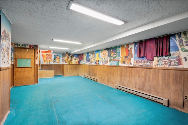 153 Waverly Rd, Scarsdale, NY 10583 - basement with baseboard heating, wood walls, carpet floors, and wainscoting