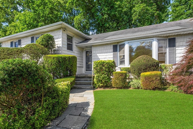 153 Waverly Rd, Scarsdale, NY 10583 - tri-level home with a front yard and a shingled roof