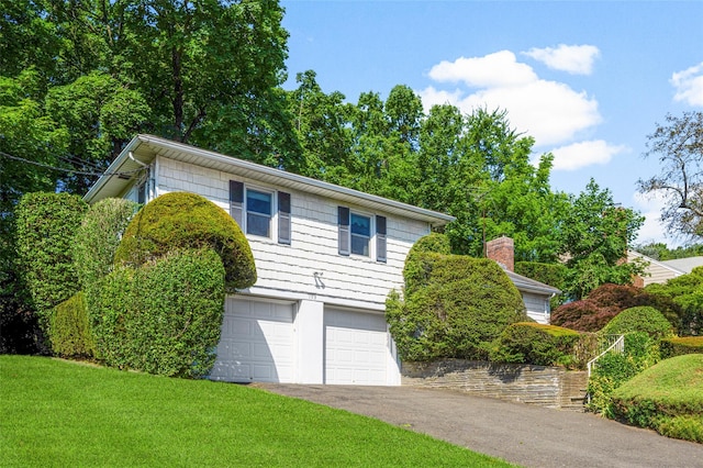 153 Waverly Rd, Scarsdale, NY 10583 - view of front of property with a garage, a front yard, and asphalt driveway