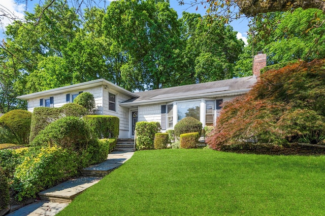 153 Waverly Rd, Scarsdale, NY 10583 - tri-level home featuring a front yard and a chimney