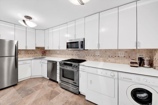 2 Fountain Ln Unit 3P, Scarsdale, NY 10583 - kitchen with appliances with stainless steel finishes, washer and clothes dryer, light countertops, and white cabinets