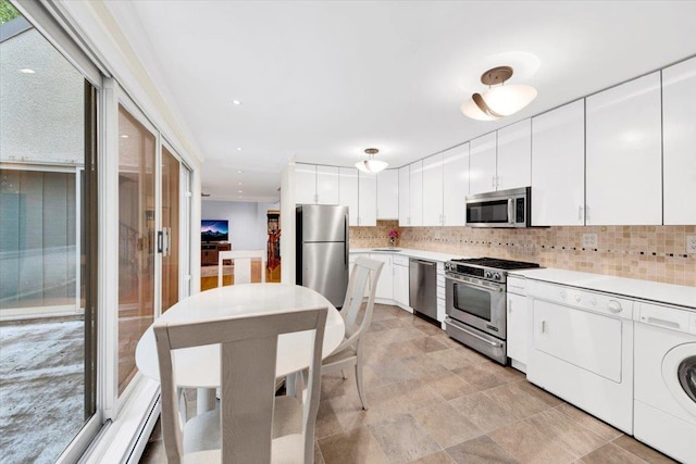 2 Fountain Ln Unit 3P, Scarsdale, NY 10583 - kitchen with appliances with stainless steel finishes, washer and dryer, backsplash, and light countertops