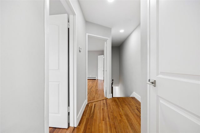 2715 Seymour Ave, Bronx, NY 10469 - corridor with an upstairs landing, wood finished floors, recessed lighting, and a baseboard radiator