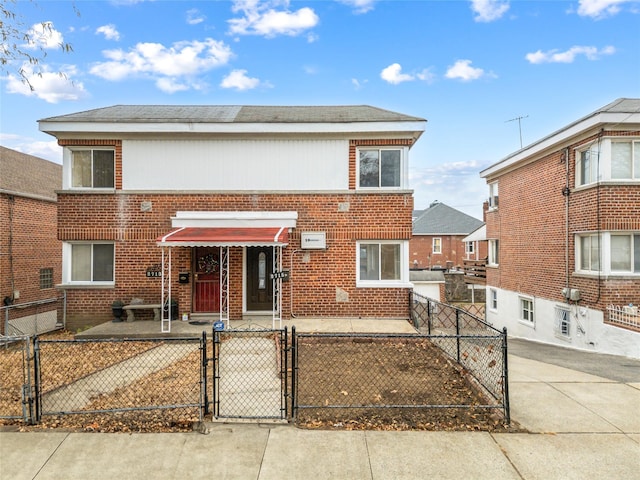 2715 Seymour Ave, Bronx, NY 10469 - townhome / multi-family property featuring a gate, brick siding, and a fenced front yard