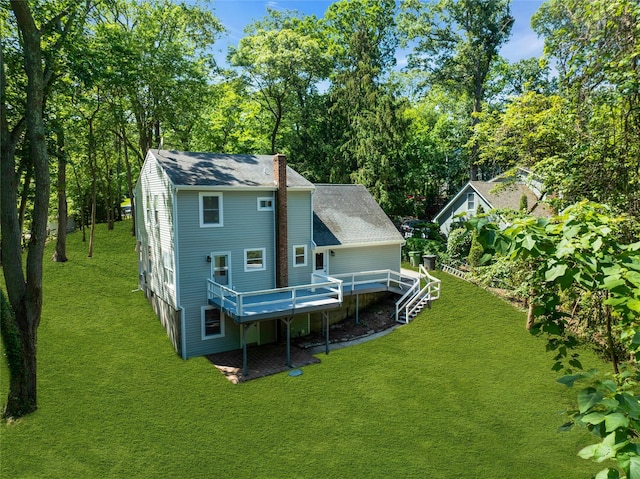 212 Sheldrake Ave, Port Jefferson, NY 11777 - back of property with a wooden deck, a lawn, roof with shingles, a chimney, and view of scattered trees