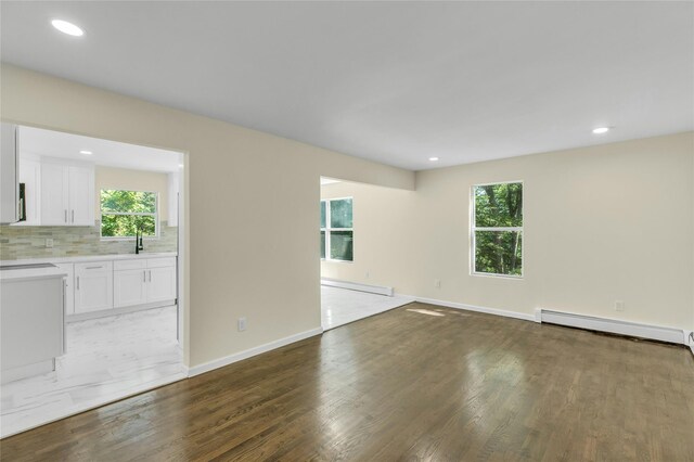212 Sheldrake Ave, Port Jefferson, NY 11777 - empty room featuring baseboard heating, a baseboard heating unit, plenty of natural light, light wood-style flooring, and recessed lighting