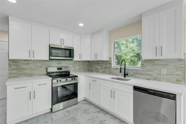 212 Sheldrake Ave, Port Jefferson, NY 11777 - kitchen featuring stainless steel appliances, light marble finish floors, white cabinetry, recessed lighting, and tasteful backsplash
