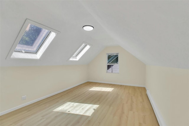 212 Sheldrake Ave, Port Jefferson, NY 11777 - additional living space featuring a skylight, light wood-type flooring, lofted ceiling, and plenty of natural light