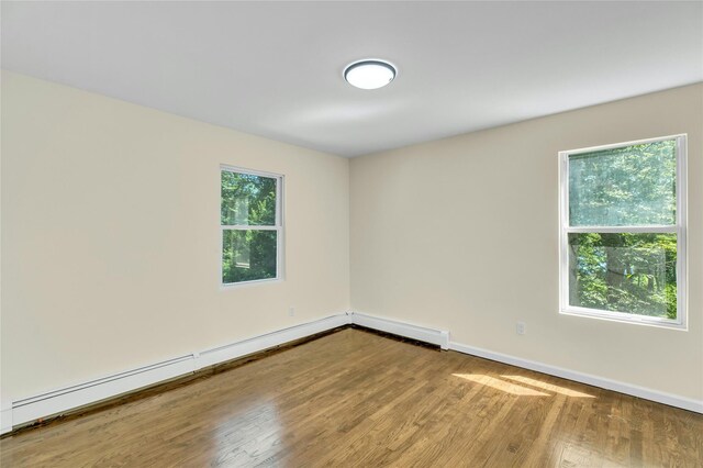 212 Sheldrake Ave, Port Jefferson, NY 11777 - unfurnished room with wood finished floors and baseboard heating