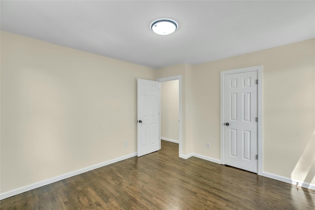 212 Sheldrake Ave, Port Jefferson, NY 11777 - unfurnished bedroom featuring baseboards and dark wood finished floors