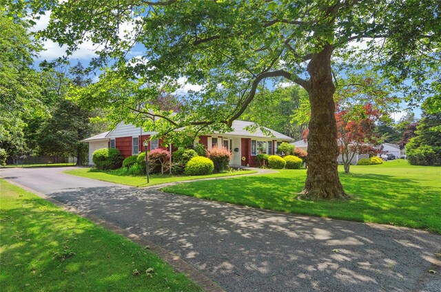 16 Colonial Dr, East Patchogue, NY 11772 - ranch-style home with a front yard and asphalt driveway