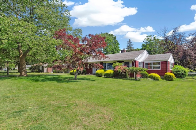 16 Colonial Dr, East Patchogue, NY 11772 - view of front facade with a front yard, a chimney, and roof with shingles