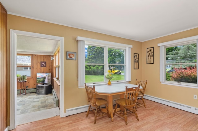16 Colonial Dr, East Patchogue, NY 11772 - dining room with light wood-type flooring, baseboard heating, a baseboard heating unit, and crown molding