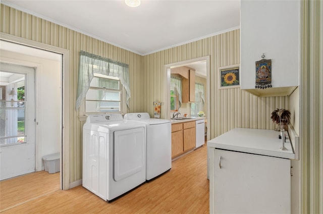 16 Colonial Dr, East Patchogue, NY 11772 - laundry area with separate washer and dryer, light wood-style flooring, ornamental molding, healthy amount of natural light, and cabinet space