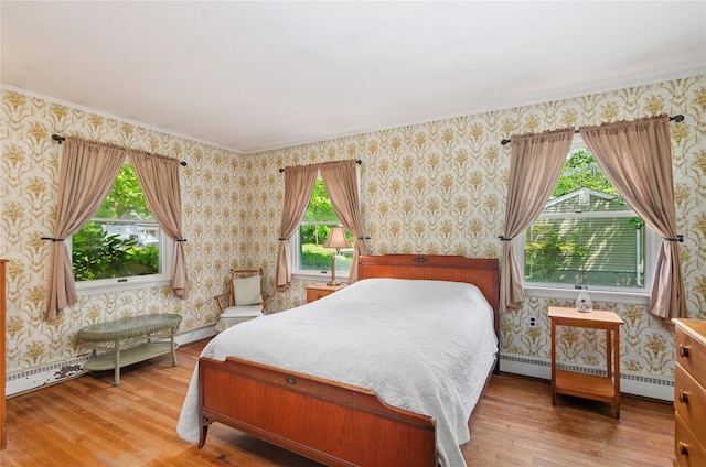 16 Colonial Dr, East Patchogue, NY 11772 - bedroom with wood-type flooring, baseboard heating, and wallpapered walls