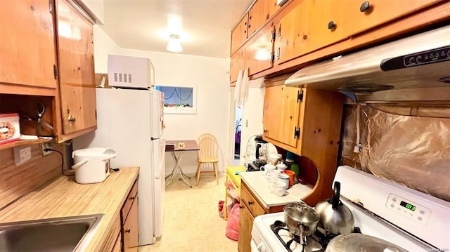 3815 149th St Unit 2D, Flushing, NY 11354 - kitchen featuring white appliances, light floors, and light countertops