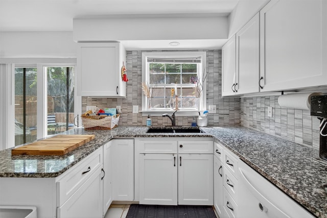 204 Watch Hill Dr, Tarrytown, NY 10591 - kitchen with white cabinetry, decorative backsplash, and dark stone counters
