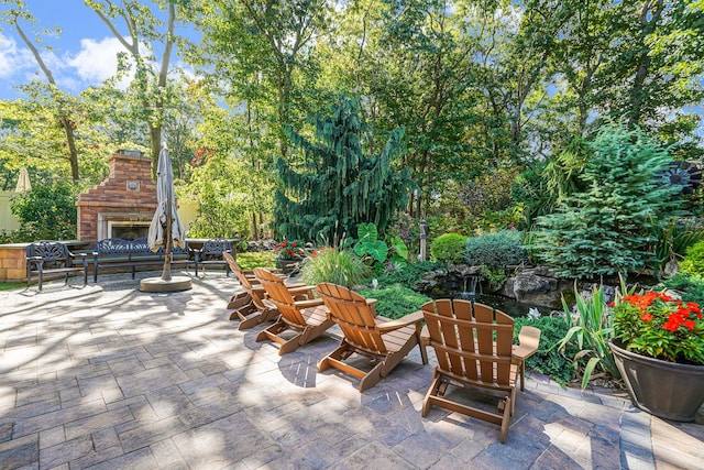 40 Independence Way, Miller Place, NY 11764 - view of patio / terrace with an outdoor stone fireplace and view of scattered trees