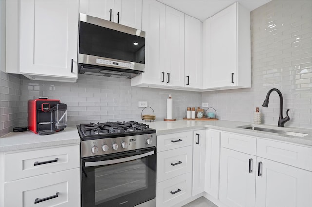 86-29 155th Ave Unit 5N, Howard Beach, NY 11414 - kitchen featuring stainless steel appliances, backsplash, light countertops, and white cabinetry