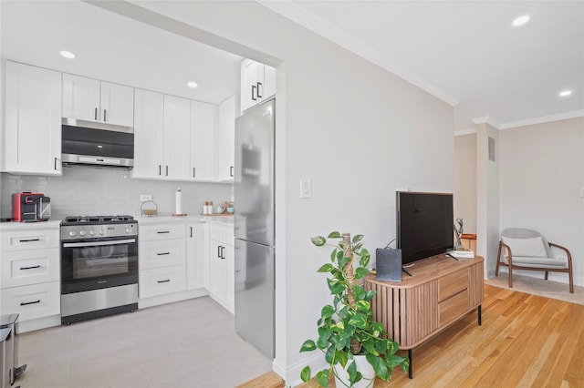 86-29 155th Ave Unit 5N, Howard Beach, NY 11414 - kitchen featuring appliances with stainless steel finishes, crown molding, decorative backsplash, light countertops, and white cabinets