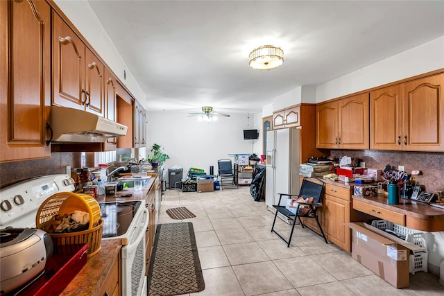 1541 Herzel Blvd, West Babylon, NY 11704 - kitchen featuring white appliances, brown cabinets, light tile patterned floors, a ceiling fan, and under cabinet range hood