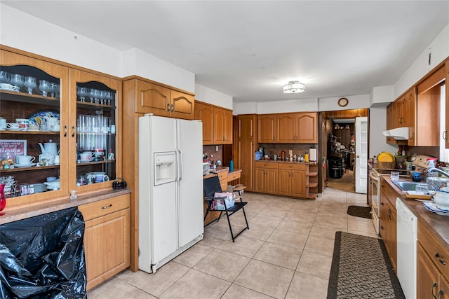 1541 Herzel Blvd, West Babylon, NY 11704 - kitchen featuring white appliances, light tile patterned flooring, under cabinet range hood, and brown cabinets