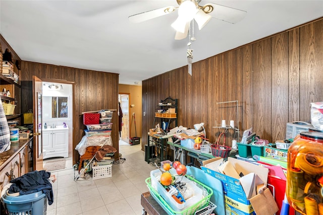 1541 Herzel Blvd, West Babylon, NY 11704 - living room featuring wood walls, light tile patterned floors, and ceiling fan
