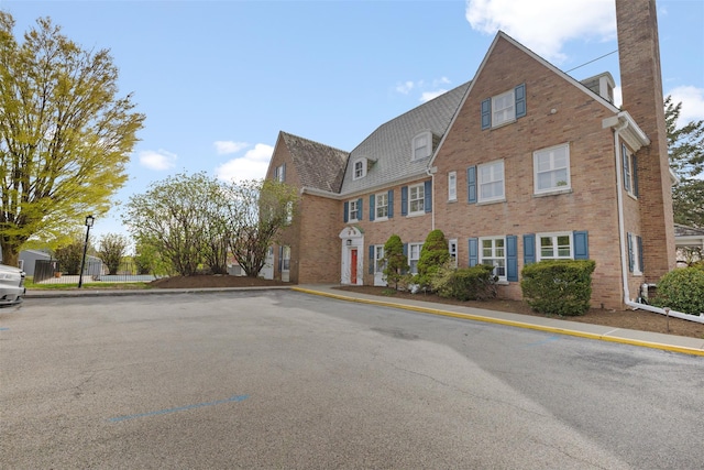83 Hudson Point Ln, Ossining, NY 10562 - view of front of home with brick siding and a chimney