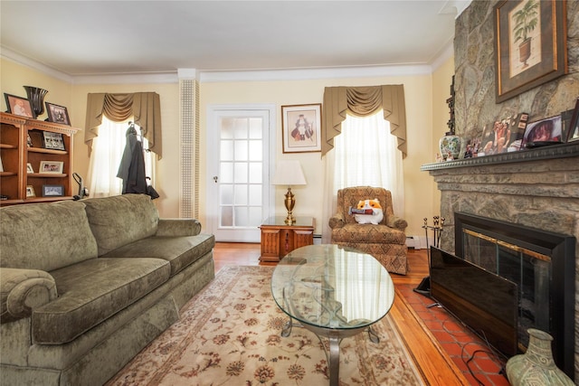 34-42 88th St, Jackson Heights, NY 11372 - living area with ornamental molding, a glass covered fireplace, a baseboard heating unit, and wood finished floors