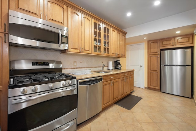 34-42 88th St, Jackson Heights, NY 11372 - kitchen featuring stainless steel appliances, light stone counters, light tile patterned flooring, glass insert cabinets, and backsplash