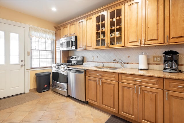 34-42 88th St, Jackson Heights, NY 11372 - kitchen with appliances with stainless steel finishes, tasteful backsplash, glass insert cabinets, and light stone countertops