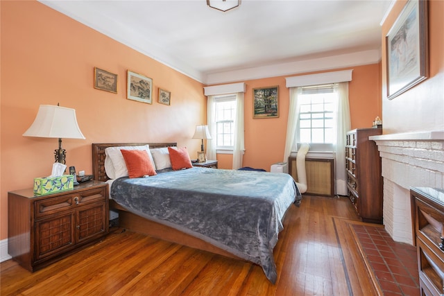 34-42 88th St, Jackson Heights, NY 11372 - bedroom featuring hardwood / wood-style floors and a brick fireplace