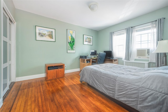 34-42 88th St, Jackson Heights, NY 11372 - bedroom featuring hardwood / wood-style flooring, an office area, radiator heating unit, and cooling unit