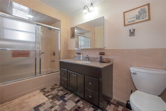34-42 88th St, Jackson Heights, NY 11372 - full bath with tile walls, vanity, enclosed tub / shower combo, and a wainscoted wall