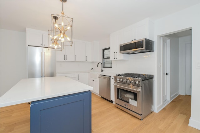 231 Macdougal St, Brooklyn, NY 11233 - kitchen with stainless steel appliances, light wood-type flooring, white cabinetry, a kitchen island, and pendant lighting