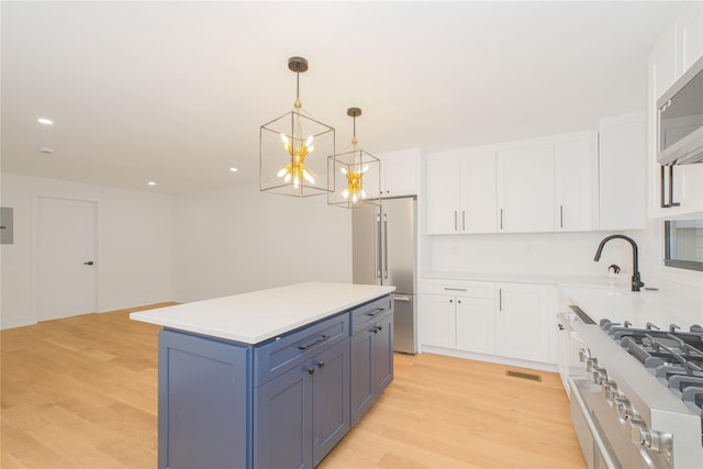 231 Macdougal St, Brooklyn, NY 11233 - kitchen with stainless steel appliances, white cabinetry, light countertops, a kitchen island, and recessed lighting
