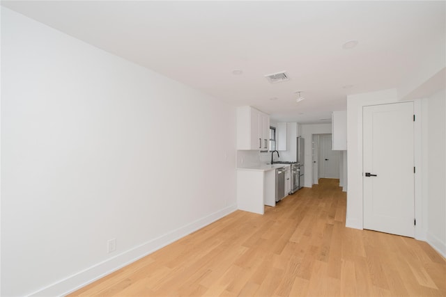 231 Macdougal St, Brooklyn, NY 11233 - unfurnished living room with light wood-style floors and baseboards