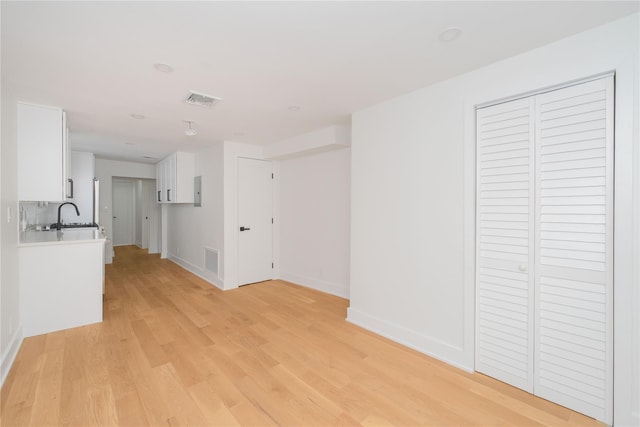 231 Macdougal St, Brooklyn, NY 11233 - unfurnished living room with light wood finished floors and baseboards