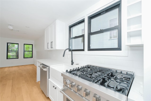 231 Macdougal St, Brooklyn, NY 11233 - kitchen featuring stainless steel appliances, white cabinets, backsplash, and light countertops