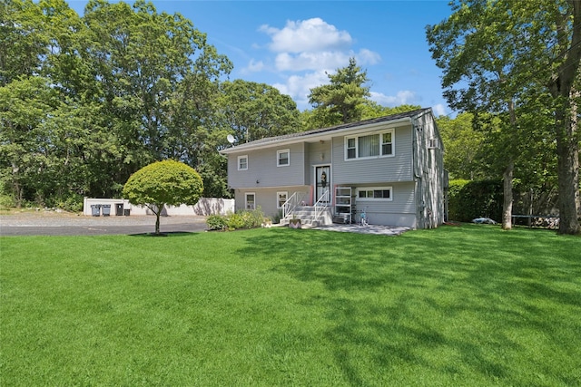 2 Prospect St, Central Islip, NY 11722 - rear view of house with a yard and view of scattered trees