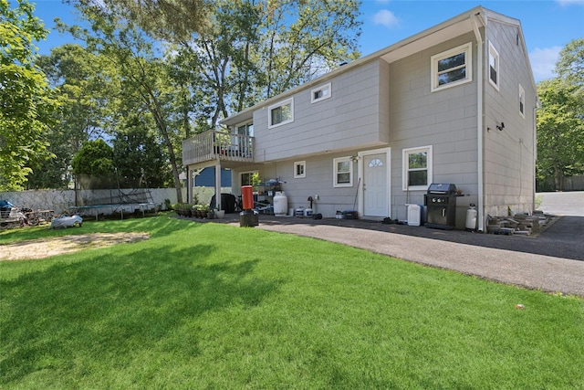2 Prospect St, Central Islip, NY 11722 - back of property with a trampoline, a patio, and a balcony