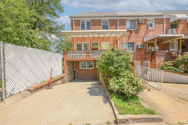 150-01 Horace Harding Expy, Flushing, NY 11367 - view of property with brick siding, driveway, and a balcony