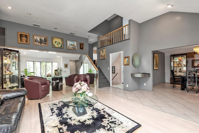 895 Cherry Ln, North Woodmere, NY 11581 - living room with a towering ceiling, stairway, and wood finished floors