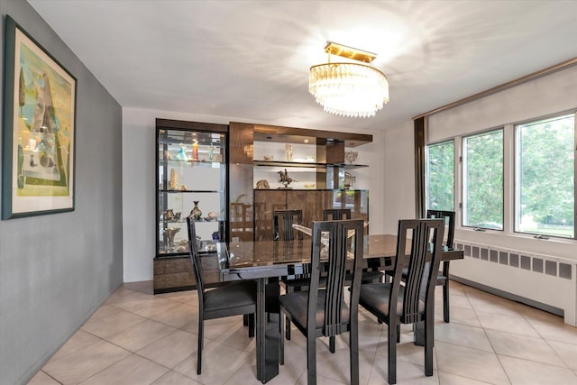 895 Cherry Ln, North Woodmere, NY 11581 - dining room featuring radiator, a chandelier, and light tile patterned floors