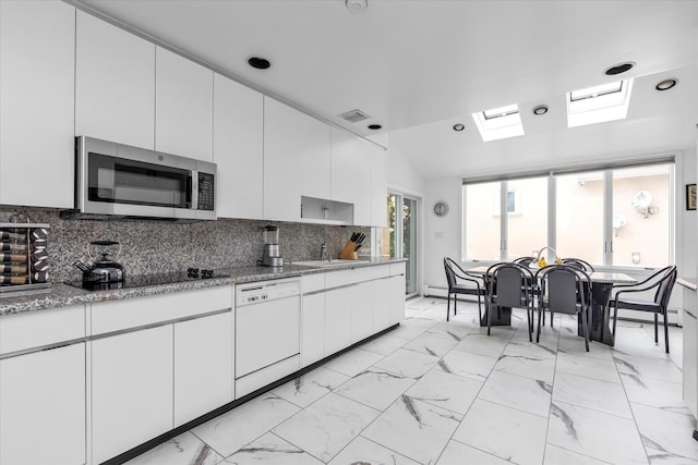 895 Cherry Ln, North Woodmere, NY 11581 - kitchen featuring dishwasher, stainless steel microwave, black electric stovetop, white cabinets, and recessed lighting
