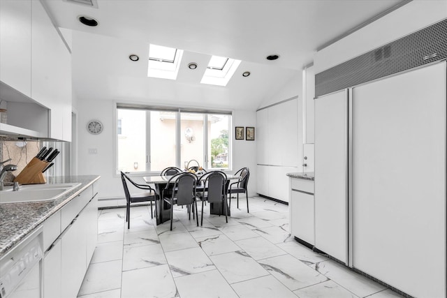 895 Cherry Ln, North Woodmere, NY 11581 - dining area featuring vaulted ceiling, a skylight, light marble finish flooring, and a baseboard heating unit