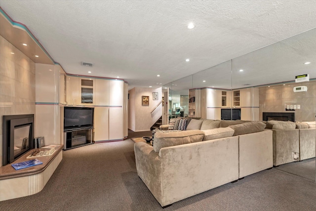 895 Cherry Ln, North Woodmere, NY 11581 - living area featuring a fireplace, recessed lighting, carpet flooring, stairway, and a textured ceiling